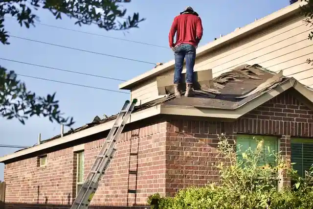 A man on a roof shows how to properly stabilize a ladder