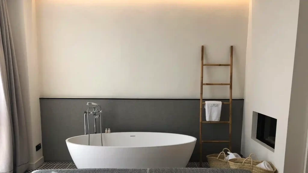 A bathroom with a ladder for hanging towels.