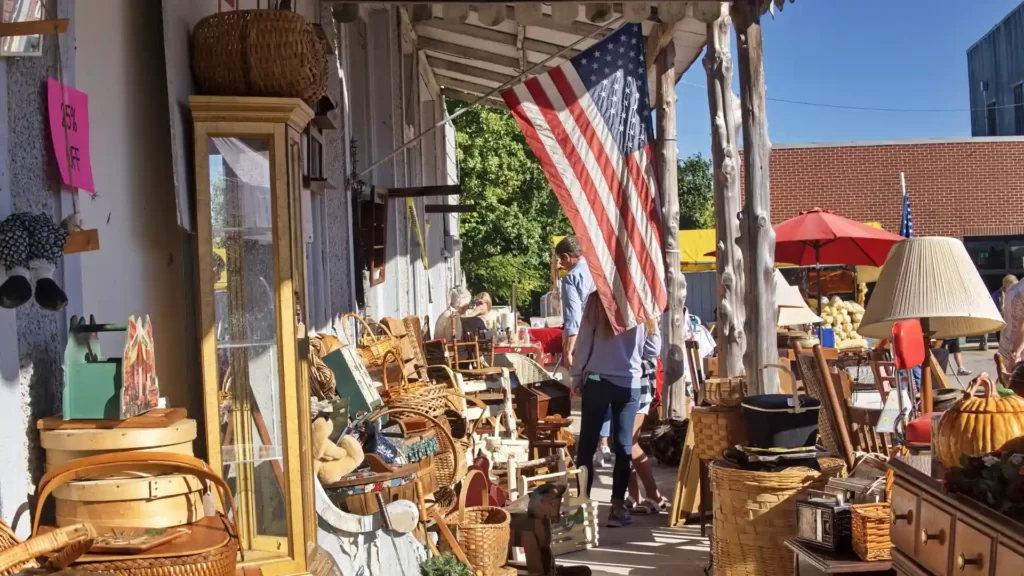 A flea market selling a lot of wooden items.