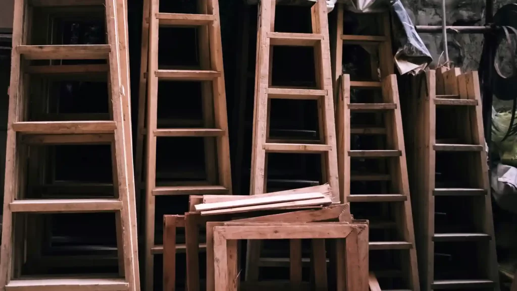 Stacks of wooden ladders.