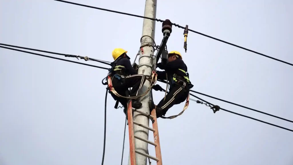 Electricians repairing a power line