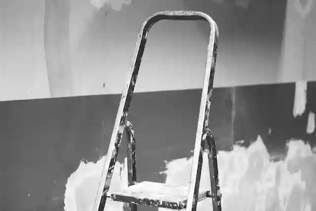 A step ladder which is definitely one of 8 different types of ladders you should know, covered in paint.