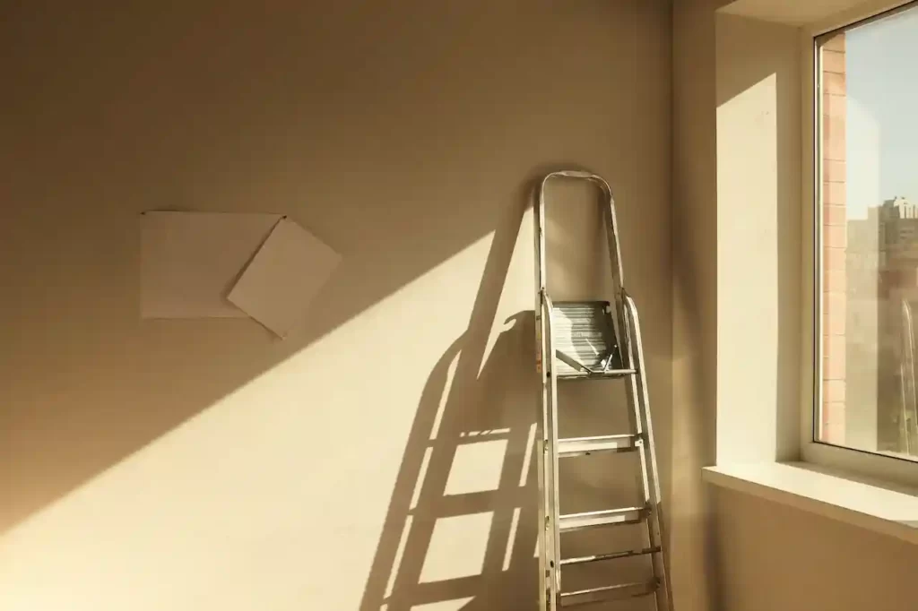 A folded ladder leaning against the wall