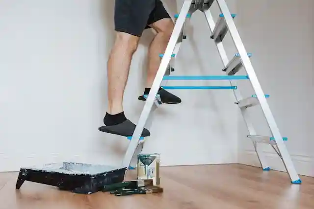 Man climbing the ladder, demonstrating before teaching your child to climb a ladder
